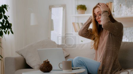 Photo for Caucasian upset woman user customer lady girl in glasses businesswoman freelancer using laptop sad frustrated about computer problem stressed about mistake software error worried read bad news at home - Royalty Free Image
