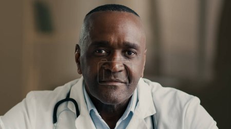 Photo for Close up face medical portrait elderly man doctor specialist general practitioner physician work at hospital african ethnic male dentist medic clinical therapist looking at camera health care concept - Royalty Free Image