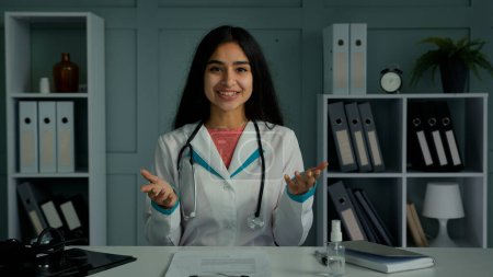 Photo for Professional young doctor arabian indian woman physician provide remote medical assistance in virtual chat. Medic female worker use video conference app consulting distant patient online webcam view - Royalty Free Image