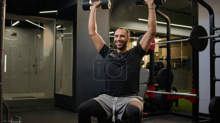 Photo for Active bodybuilder multiracial African American man lifting heavy weights dumbbells sport workout in gym healthy lifestyle male sportsman fitness trainer athlete training sports exercise strong muscle - Royalty Free Image