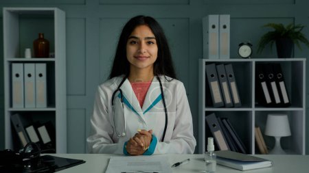 Photo for Professional young doctor arabian indian woman physician provide remote medical assistance in virtual chat. Medic female worker use video conference app consulting distant patient online webcam view - Royalty Free Image