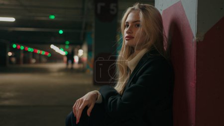 Photo for Stressed Caucasian woman female victim hiding alone in underground shelter girl lost in night parking suffer from danger abuse fight war bombing lady feeling afraid and despair thinking of loneliness - Royalty Free Image