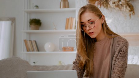 Photo for Caucasian woman in glasses student girl lady employer manager businesswoman freelancer female with laptop at home office working online distant job studying work with computer app internet shopping - Royalty Free Image