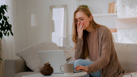 Photo for Caucasian shocked woman in glasses looking at laptop reading bad news close mouth with hands holding head with shock failure student girl lost with computer businesswoman worry about business problem - Royalty Free Image