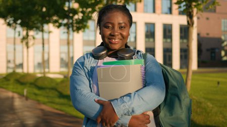 Photo for Portrait African American woman schoolgirl teen study university college campus academy student teenager girl high school education holding books schoolbag smiling toothy at camera in city outdoors - Royalty Free Image