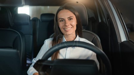 Photo for Happy joyful toothy smiling Caucasian woman smile looking at camera sit inside new rental luxury modern car girl female driver in automobile driving auto transport businesswoman lady at parking lot - Royalty Free Image