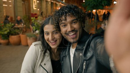 Photo for In evening night city happy Indian Arabian couple in love woman man people make selfie photo webcam web camera view travel dating posing photographing picture together relationship vacation adventure - Royalty Free Image