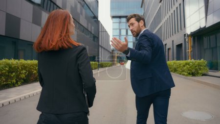 Photo for Back view worker two partners people business colleagues coworkers businessman businesswoman walk in city late man motivate woman hurry rush running to urgent meeting at office run together hurrying - Royalty Free Image
