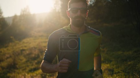 Photo for Close up focused adult Caucasian male man guy athlete sport sprinter runner jogging running race run trail sunshine training outside countryside nature hill. Motivation healthcare bodybuilder workout - Royalty Free Image