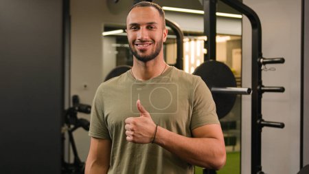 Photo for Bodybuilder African American man happy satisfied cool like perfect good result gesture showing thumb up approve recommend in gym healthy lifestyle fitness guy in sport club exercise workout athlete - Royalty Free Image