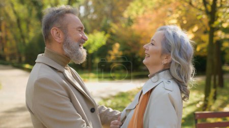 Photo for Caucasian family old mature woman man love happy faces of senior couple touching noses cute cuddling in nature autumn park elderly male husband and female wife in retirement bonding outdoors laughing - Royalty Free Image