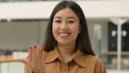 Asian woman looking at camera invite to join appeal chinese korean japanese girl businesswoman inviting gesture come here smiling female HR manager of business office firm calling welcome invitation