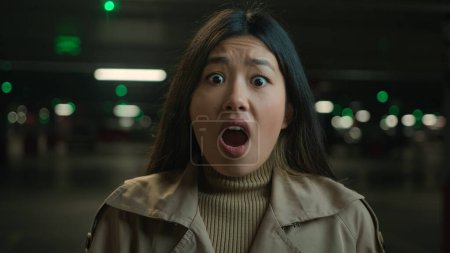 Téléchargez les photos : Peur fille asiatique chinois japonais femme choqué mauvaise nouvelles peur coréen dame dans voiture parking souterrain bouche ouverte sentir horreur terrifié émotion faciale regarder caméra panique choc peur stress - en image libre de droit