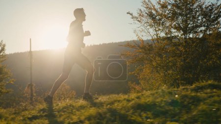 Photo for Happy Caucasian male man guy athlete sport sprinter runner jogging running marathon training healthy active lifestyle run high mountain workout body exercise fitness sunrise sunlight outdoors nature - Royalty Free Image