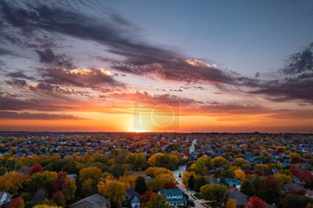 Photo for Sunset in October over the neighborhood. High quality photo. Aerial image of fall colors just as the sun is setting. - Royalty Free Image
