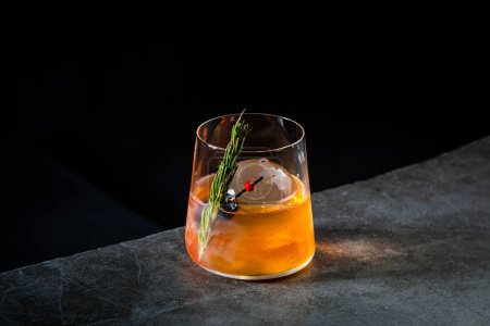 Photo for Aromatic cocktail with a sprig of pine needles and round ice - Royalty Free Image