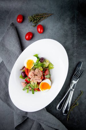Photo for Salad with soft-boiled egg, tuna, green onions, boiled potatoes - Royalty Free Image