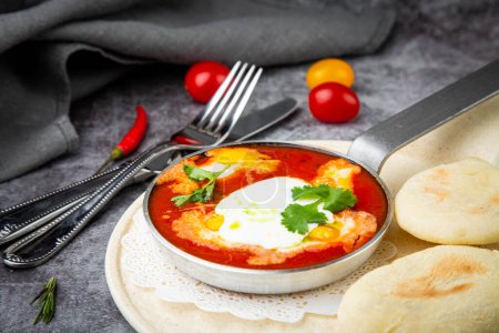 Photo for Borscht in a frying pan with fresh flatbreads - Royalty Free Image