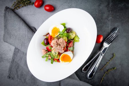 Photo for Salad with soft-boiled egg, tuna, green onions, boiled potatoes - Royalty Free Image