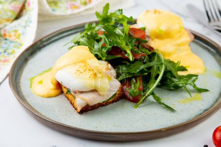 Photo for Breakfast of arugula and tomato, toast with cheese and poached egg - Royalty Free Image