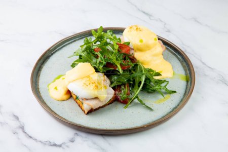 Photo for Breakfast of arugula and tomato, toast with cheese and poached egg - Royalty Free Image