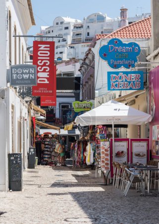 Albufeira, Portugal - June 24, 2023: Tourists relaxing at seaside resort town of Albufeira in southern Algarve region of Portugal during the summer