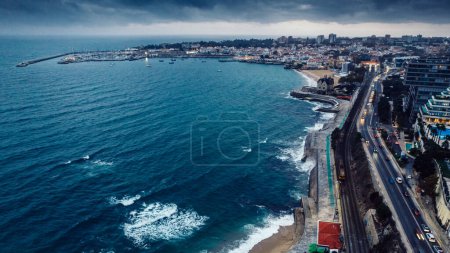 Photo for Aerial drone view of Marginal Avenue and coastline with looking west towards Cascais on a cloudy autumn day. - Royalty Free Image