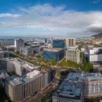 A breathtaking panoramic vista unfolds showcasing the urban skyline of Cape Town, South Africa, with the majestic Table Mountain looming in the background