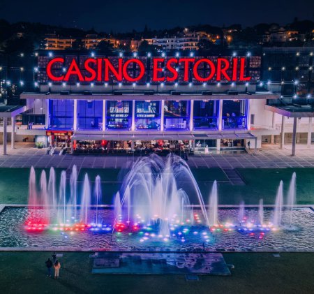 Photo for Estoril, Portugal - April 20, 2024: Facade of Estoril Casino at night located in Estoril, Portugal 30km from Lisbon. One of largest casinos in Europe and inspiration for Ian Fleming's Casino Royale - Royalty Free Image