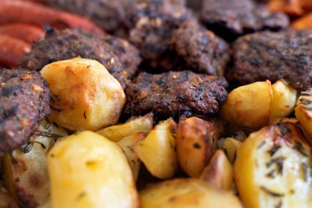 Photo for Mixed grill meat with roasted potatoes - Royalty Free Image