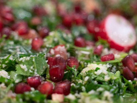 Photo for Fresh cut cuscus and vegetables salad with arugula and pomegrant seeds and radish - Royalty Free Image