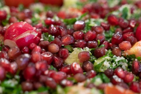 Photo for Fresh cut cuscus and vegetables salad with arugula and pomegrant seeds and radish - Royalty Free Image