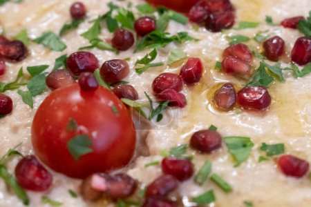 Photo for Fresh Tehina spread with pomegranate seeds , olive oil and coriander - Royalty Free Image