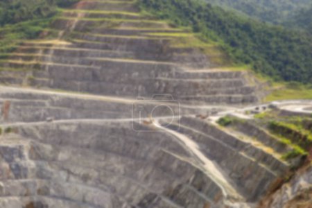 Foto de Blurred background of open pit mining. Aerial view of industrial slope on mineral mine site. - Imagen libre de derechos