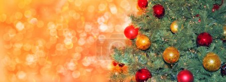 green christmas tree with red and yellow balls, with lights and highlights, festive concept, form for greeting card, copy space Poster 626269732