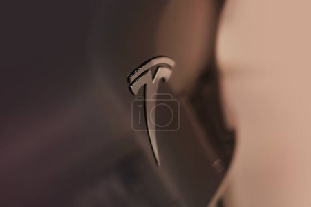 Photo for Closeup chromium-plated Logotype, Tesla car model Y in liquid silver dubbed Mercury Silver Metallic color, popular passenger electric vehicle, Elon Musk, American company, Frankfurt - December 2022 - Royalty Free Image