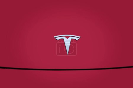 Photo for Chromium-plated Logotype Tesla Motors in Deep Crimson Multicoat, popular passenger electric car, Elon Musk, Tesla is an American company, electric vehicle production, Frankfurt - December 2022 - Royalty Free Image