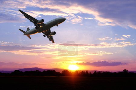 Photo for Black silhouette of airplane in beautiful colorful dramatic sky with cloud, handsome sunset, concept flight in heavenly space, meditative calmness, international transportation, cargo transportation - Royalty Free Image