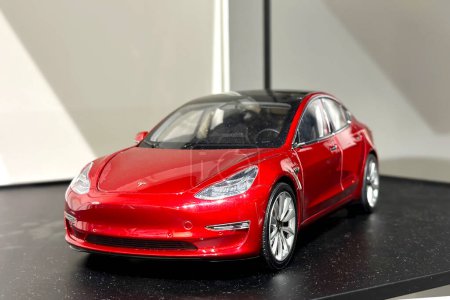 Photo for Red reduced copy, toy, Tesla car model, electric vehicle in showcase, alternative energy development concept, Elon Musk company, Frankfurt - January 2023 - Royalty Free Image