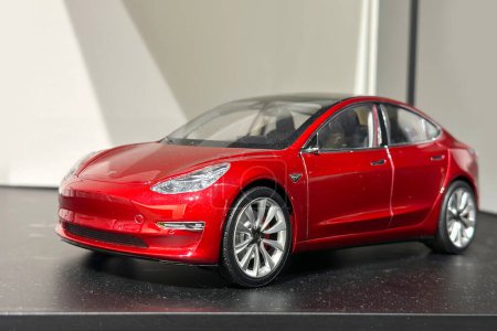Photo for Red reduced copy, toy, Tesla car model, electric vehicle in showcase, alternative energy development concept, Elon Musk company, Frankfurt - January 2023 - Royalty Free Image