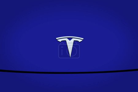 Photo for Closeup chromium-plated Logotype Tesla Motors on blue hood, most popular passenger electric car in world, Elon Musk, Tesla American company, electric vehicle production, Frankfurt - December 5, 2022 - Royalty Free Image