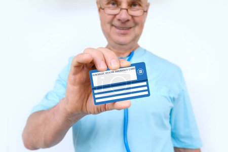 Photo for Doctor holds electronic public health insurance cheaper, Insurance Card EU, concept healthcare assistance, medical support on trip to Europe, emergency treatment services, healthcare coverage abroad - Royalty Free Image