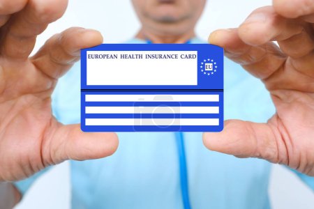 Photo for Doctor holds European health insurance card, blue EU document healthcare support, medical expenses, emergency, international Travel insurance EU and EFTA traveling, healthcare guarantee - Royalty Free Image