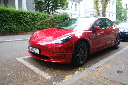 Photo for Red electric car parked on street, popular sedan from company Elon Musk, alternative energy development concept, clean energy, electric vehicle innovation, Frankfurt - July 1, 2023 - Royalty Free Image