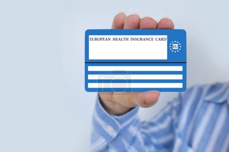 Photo for European health insurance card in female hand, blue EU document healthcare support, medical expenses, emergency, international Travel insurance EU and EFTA traveling, healthcare information - Royalty Free Image