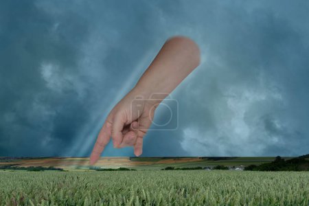 Photo for Female hand points with index finger, dramatic thunderstorm sky with dark clouds, concept God's punishment, retribution for sins, global warming problem, natural disasters, hurricane, typhoon, storm - Royalty Free Image