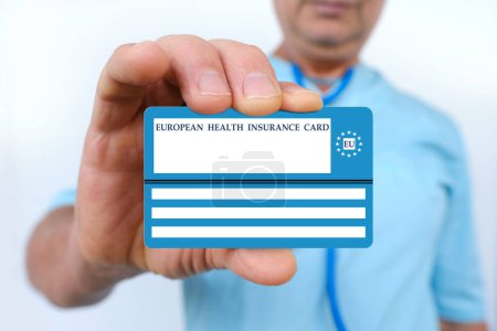 Photo for Electronic public health insurance cheaper, Insurance Card EU in male doctor's hand, concept medical support on trip to Europe, emergency treatment services, healthcare coverage abroad, card security - Royalty Free Image