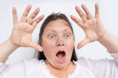 Photo for Humorous Facial Expressions, middle-aged mature woman with bulging eyes, upper face close-up, goggle eyes in fright, staring at camera, Very strong surprise or fright, horror in look - Royalty Free Image