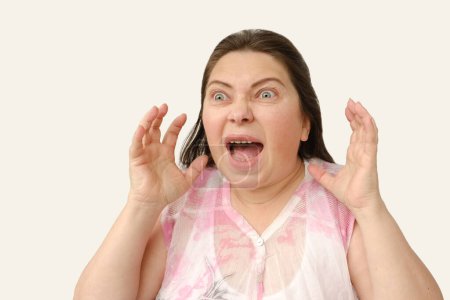 Photo for Frightened mature woman with bulging eyes in fear, Facial Expressions, Very strong surprise or fright, horror in look, surprised, shocked by news, event - Royalty Free Image
