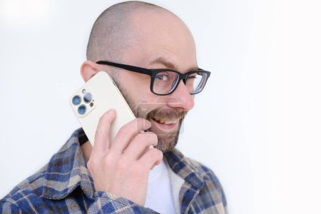 Photo for Young man in glasses using modern phone with smile, highlighting role of gadgets in everyday business communication, Tech and Work - Royalty Free Image